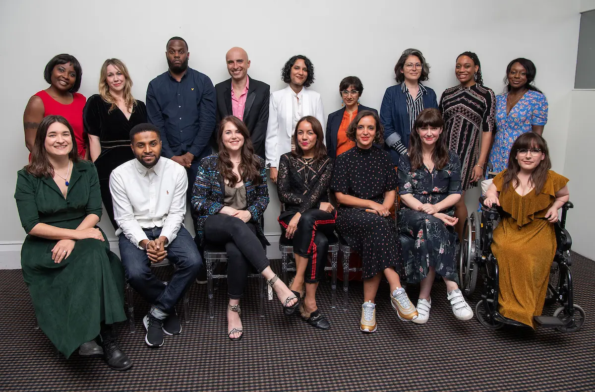 Two rows of Elevate participants in front of a white background.