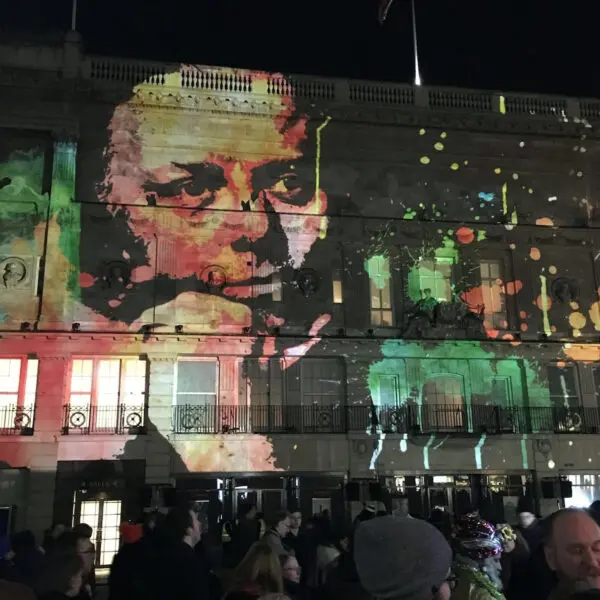 A projection of an image of Richard Attenborough on the side of the BAFTA 195 building.