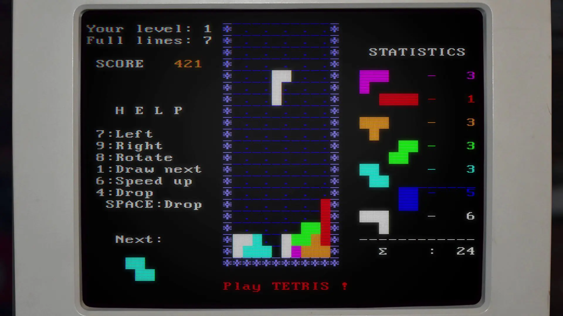 An array of coloured blocks dropping down a screen with the words Play Tetris below.