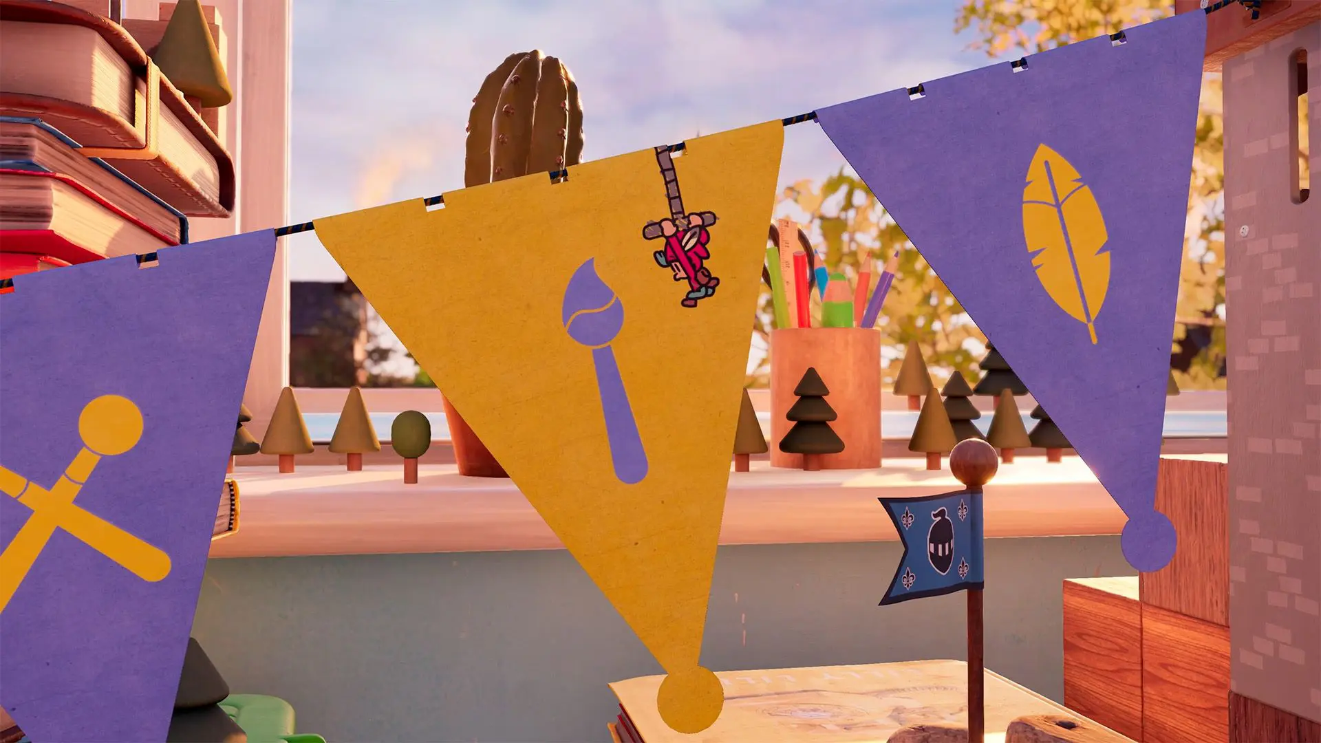 A window ledge with plants and a pen pot on and bunting in the foreground.